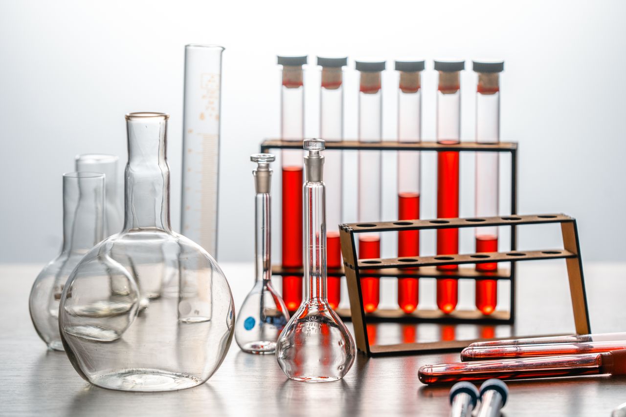 awards-img Close-up of various lab glassware with red liquids, ideal for scientific or educational use.